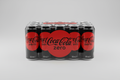 
“A clean product photo of a 24-pack of Coca-Cola Zero 330 ml cans on a plain light background, the cans neatly arranged, modern lighting, high quality e-commerce style.”